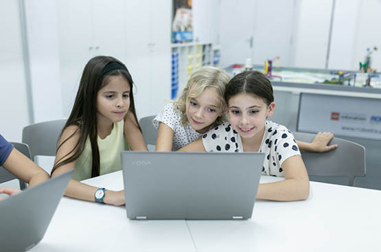Imagen de tres niñas con un ordenador en la  2ª edición de Aquae STEM